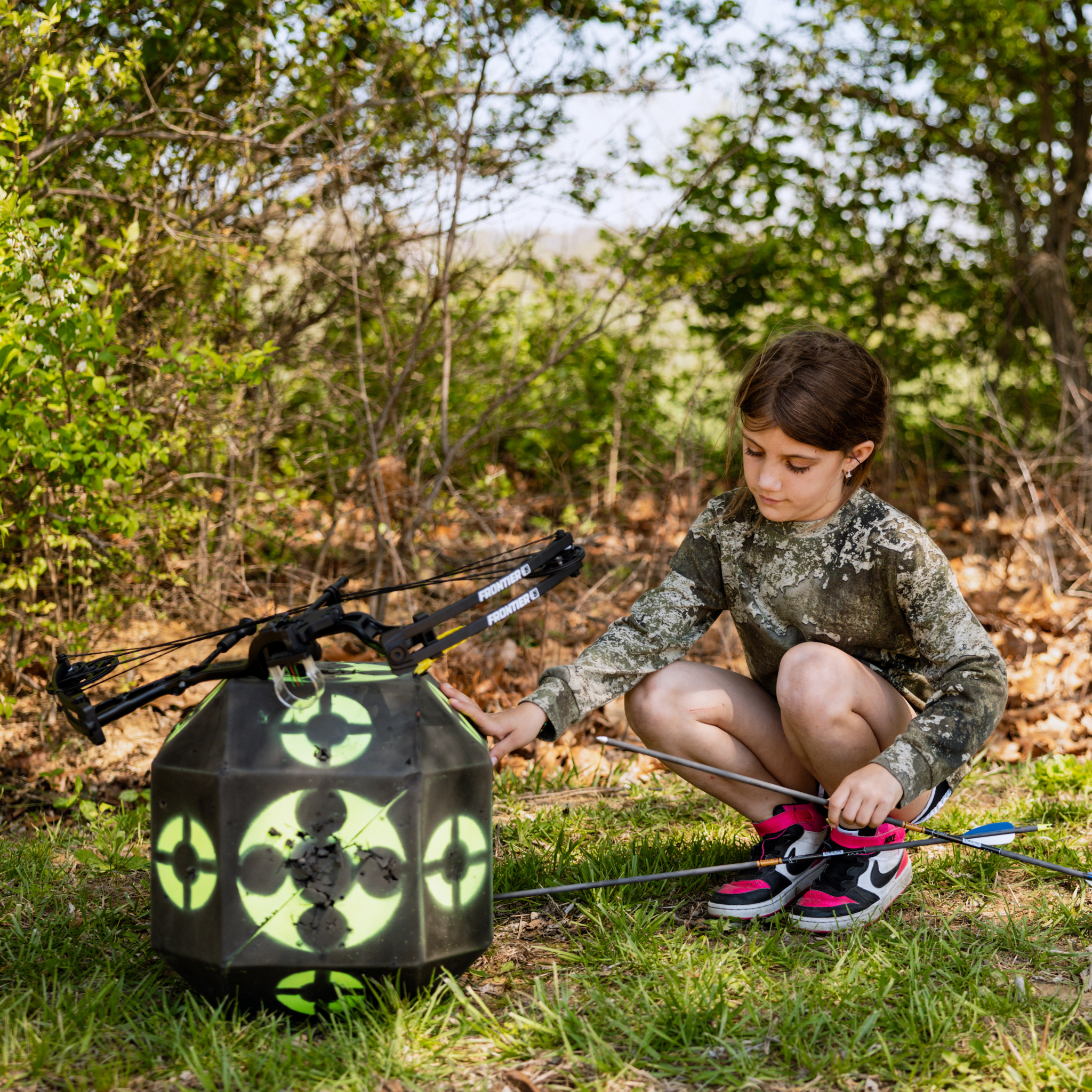 Youth Pulling Gold Tip Lightning Arrows Out of Block Target